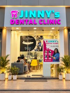 Front of Dr. Jinny's Dental Clinic with the illuminated sign